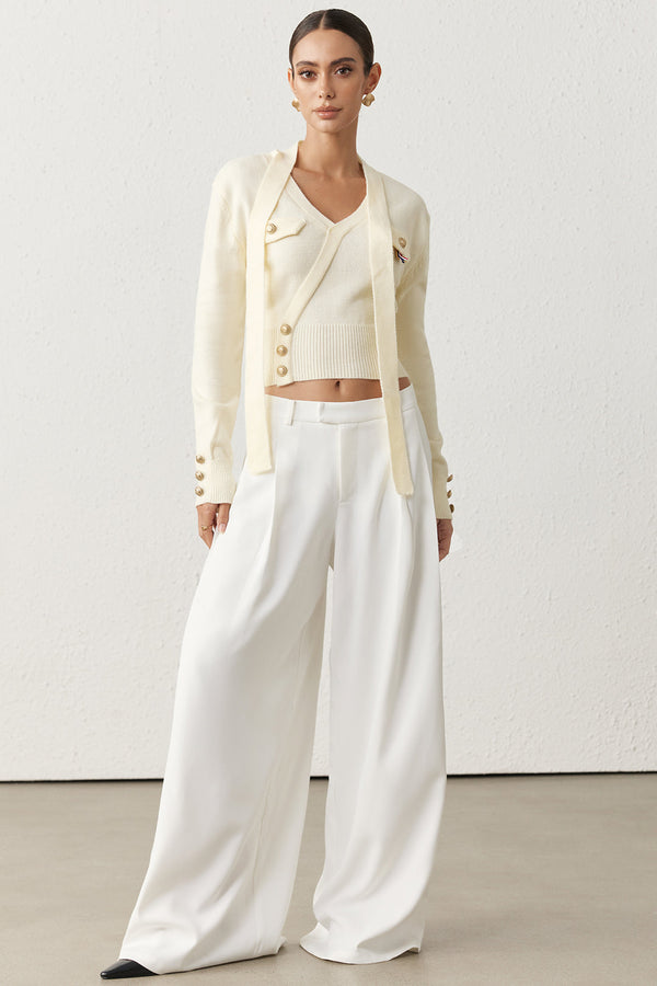 Asymmetrische metallic top met knoopjes en strik