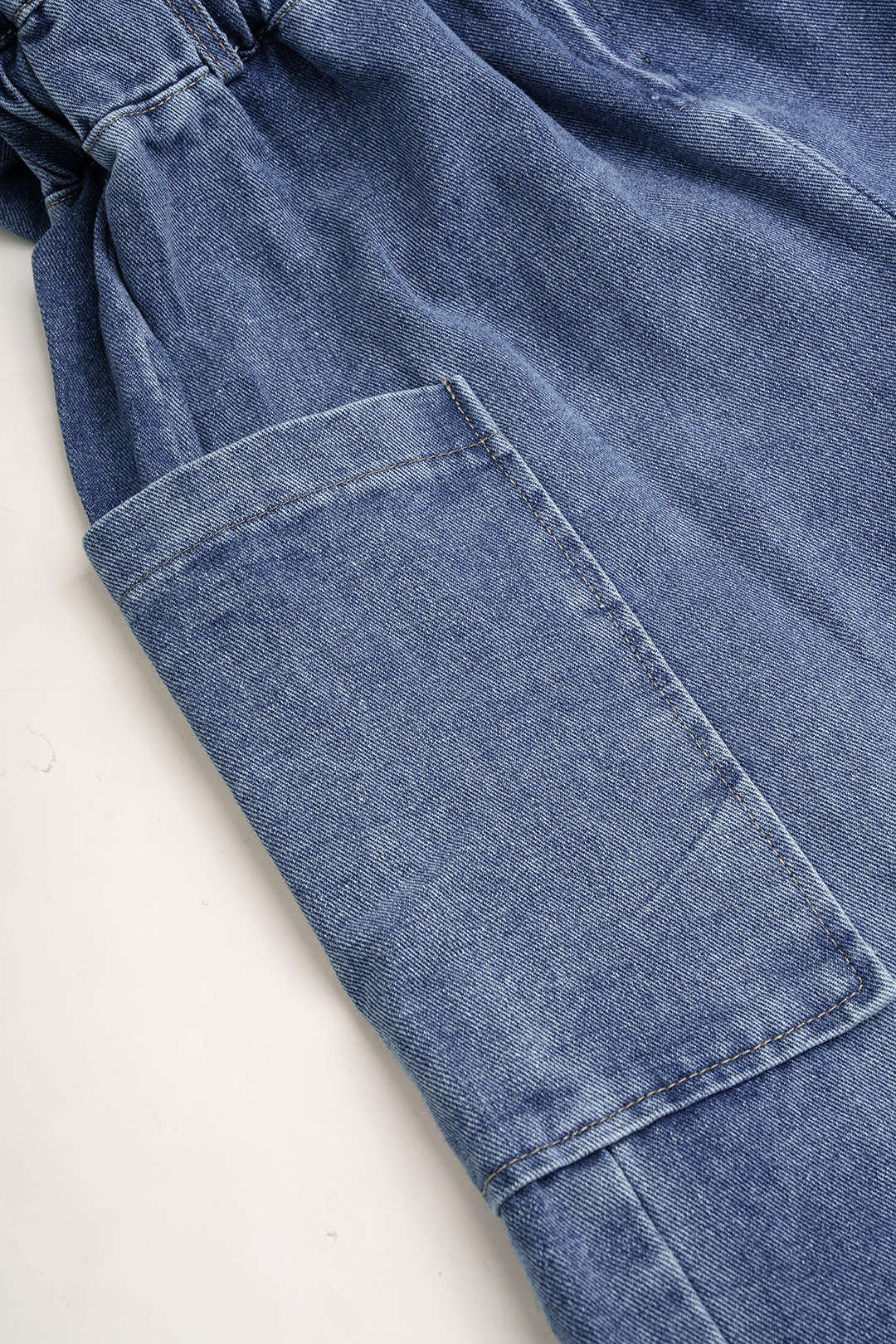 Denim patchwork jumpsuit met zakken en lange mouwen
