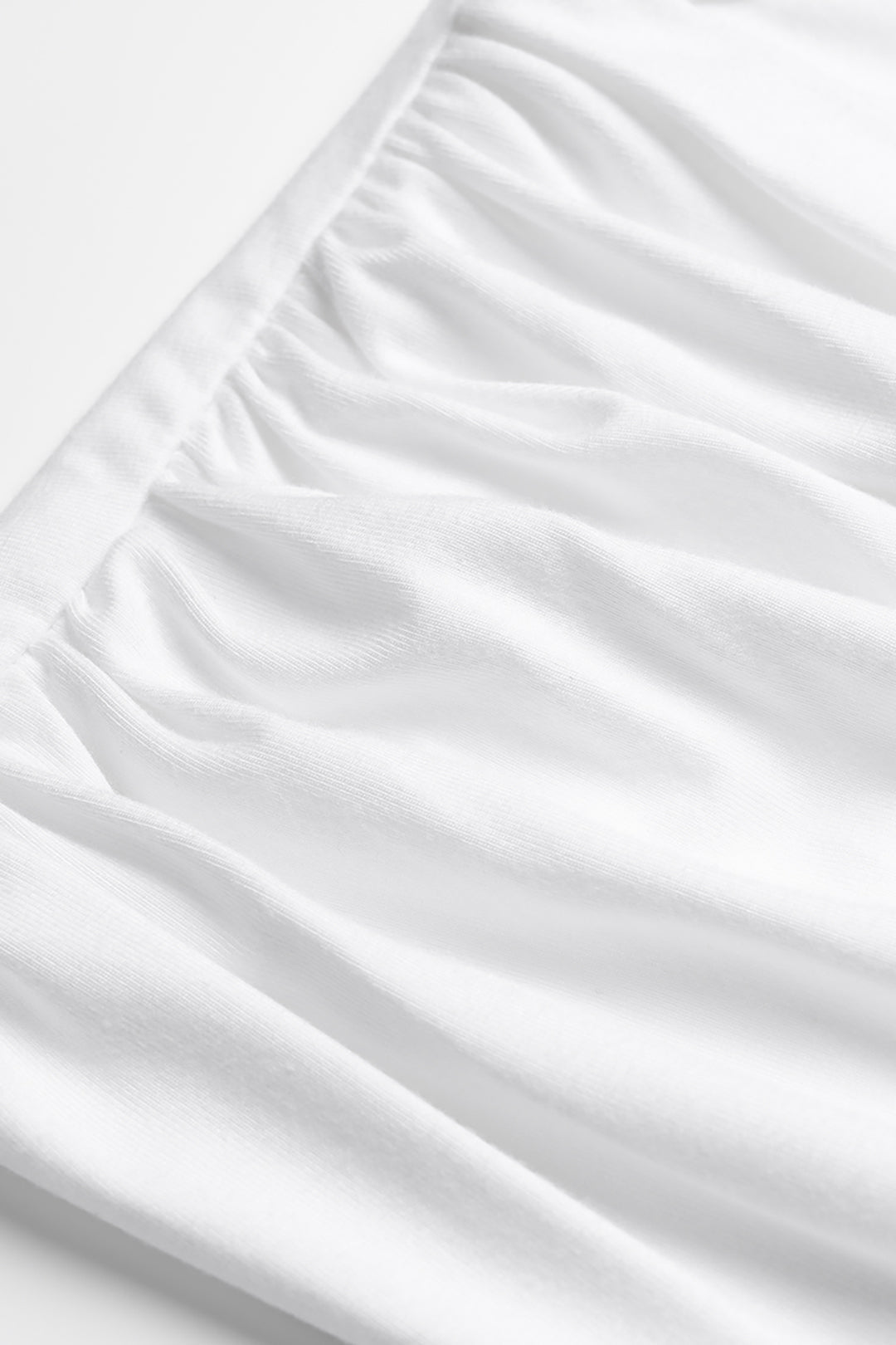 Asymmetrische mouwloze body met ronde hals en ruches