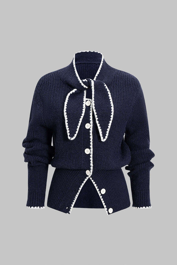 Gebreid vest met knoopjes en strik