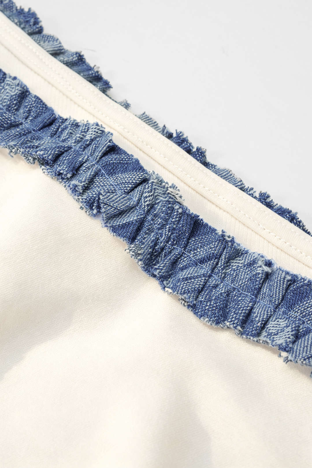 Patchwork denim sweater met één schouder