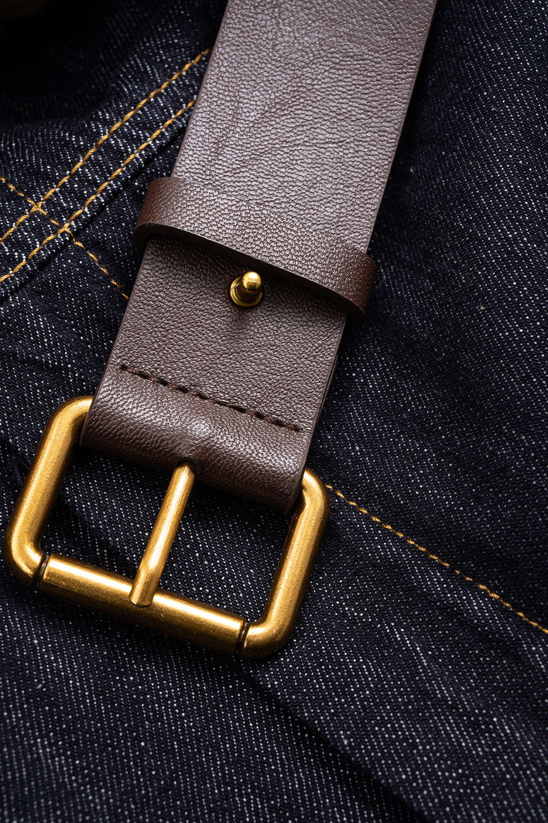 Denim leren-look jumpsuit met riem en lange mouwen